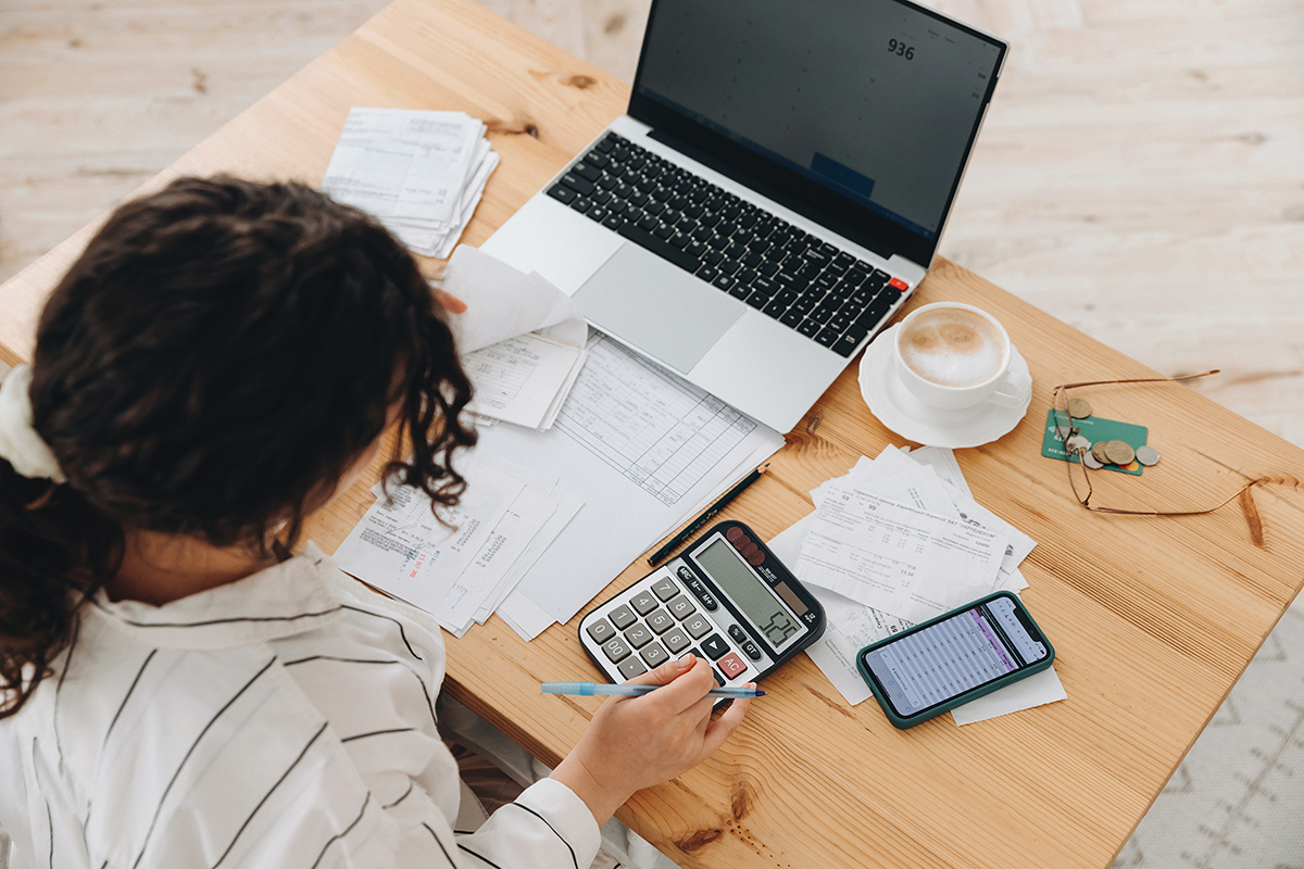woman with a calculator and bills