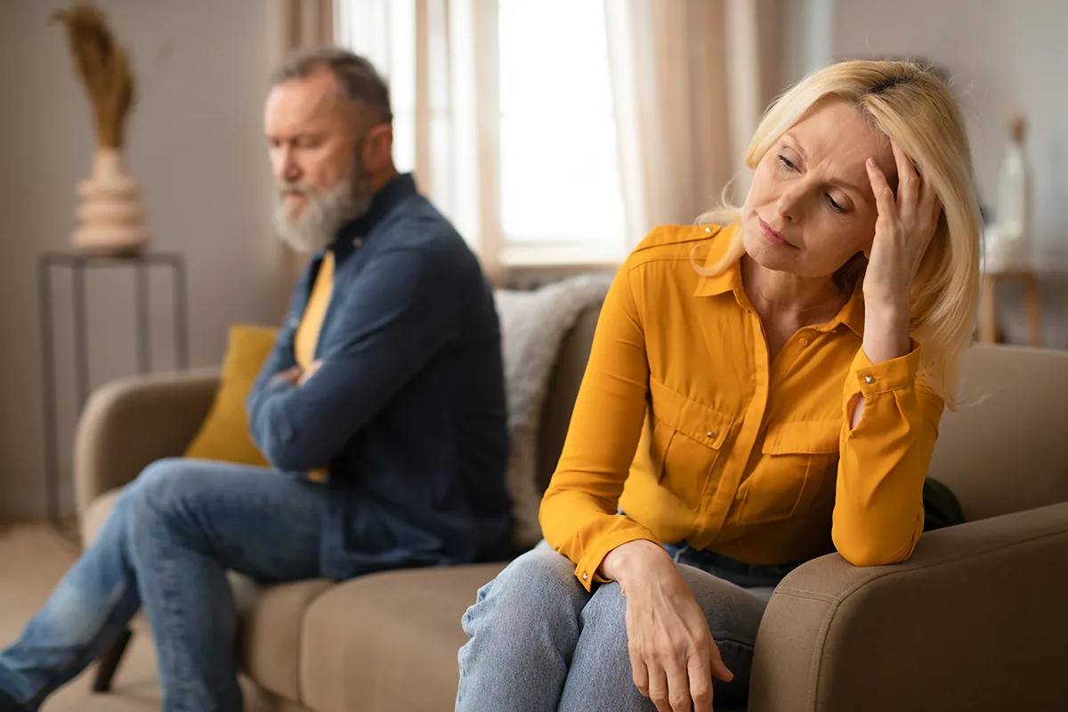 Wedding rings resting on divorce paperwork, representing gray divorce among older adults